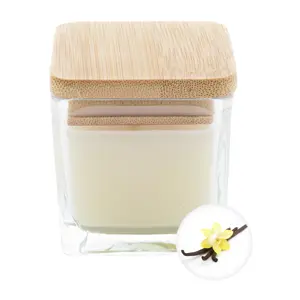 Candela profumata a base di cera vegetale in contenitore di vetro con coperchio in bambù